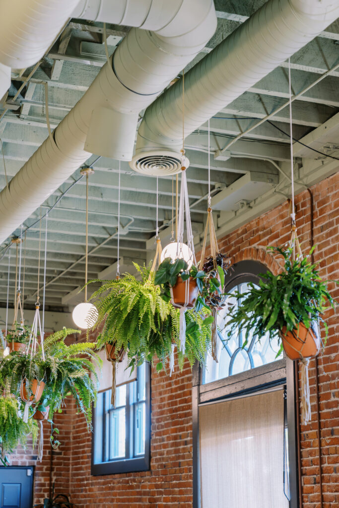 orange and plant themed wedding reception and ceremony decor at a midtown Sacramento wedding photographed by Sacramento wedding photographer