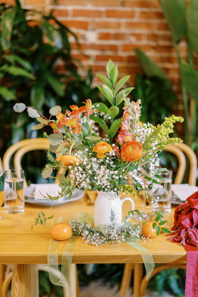 orange and plant themed wedding reception and ceremony decor at a midtown Sacramento wedding photographed by Sacramento wedding photographer