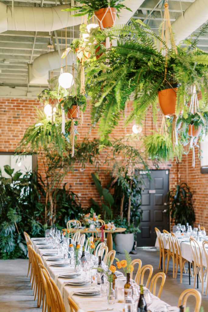 orange and plant themed wedding reception and ceremony decor at a midtown Sacramento wedding photographed by Sacramento wedding photographer