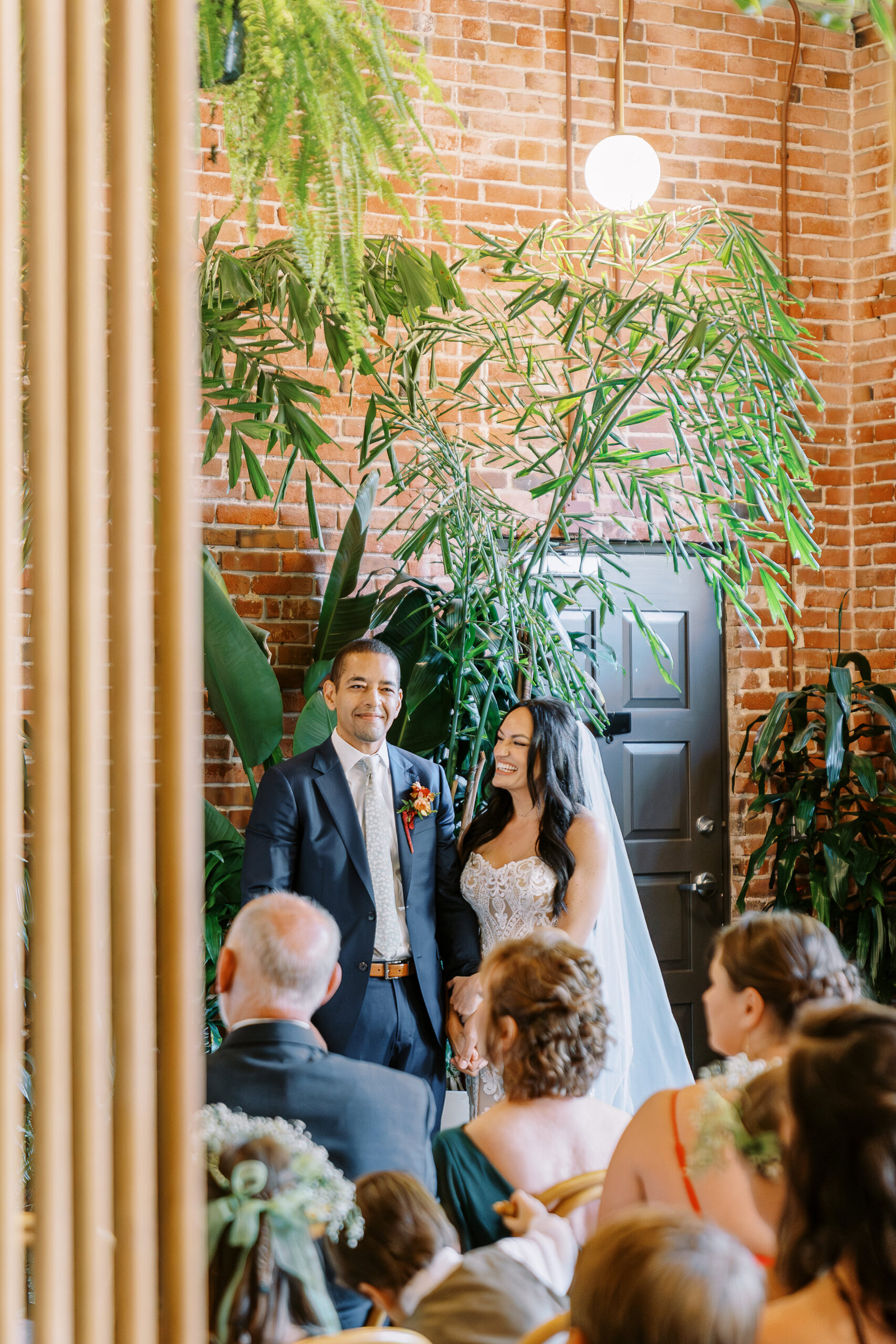 a bride and groom exchanges their vows at their midtown Sacramento wedding ceremony photographed by Sacramento wedding photographer