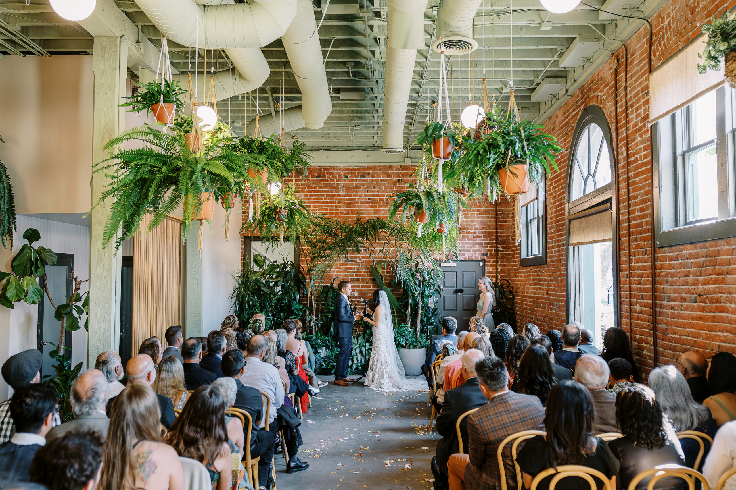 a bride and groom exchanges their vows at their midtown Sacramento wedding ceremony photographed by Sacramento wedding photographer