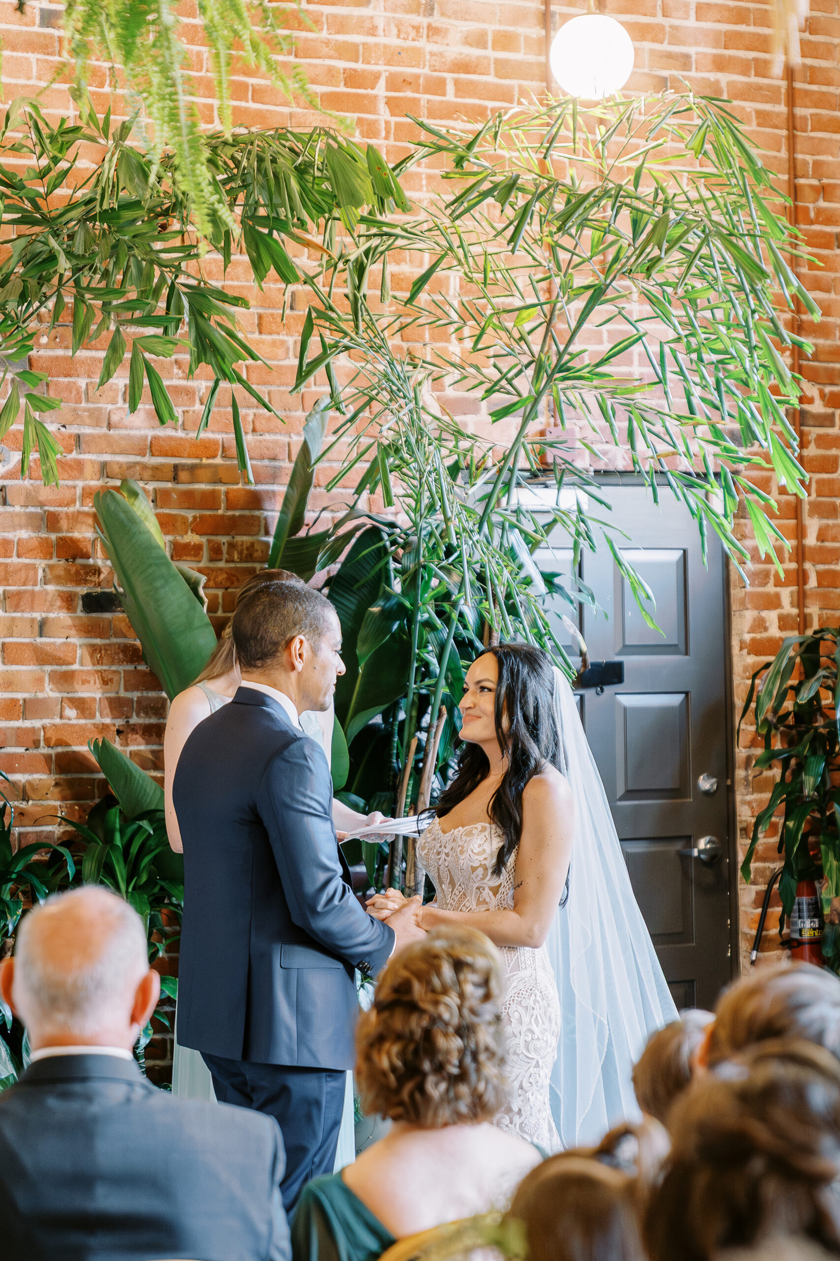 a bride and groom exchanges their vows at their midtown Sacramento wedding ceremony photographed by Sacramento wedding photographer