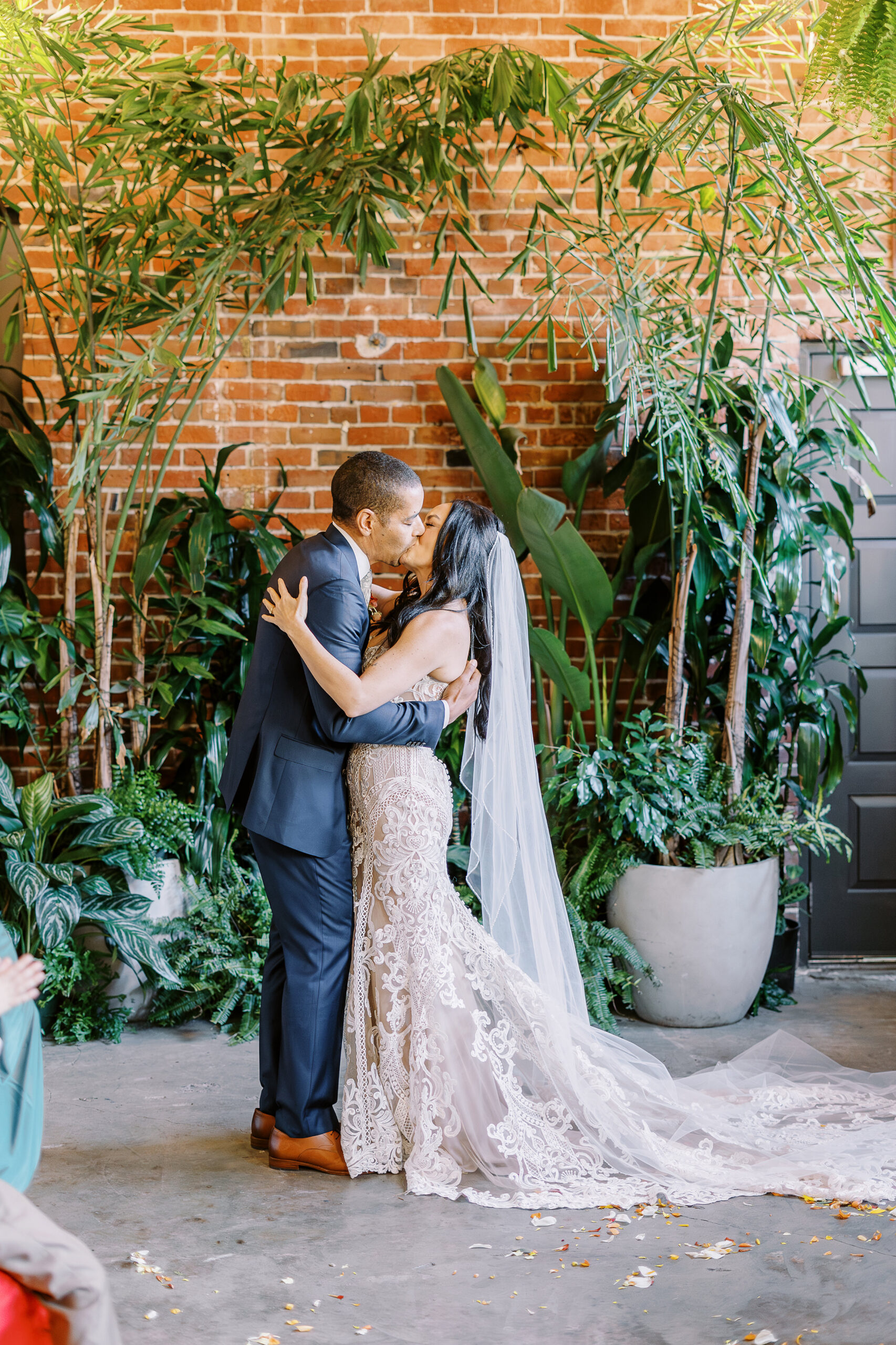 a bride and groom shares their first kiss as husband and wife at their midtown Sacramento wedding ceremony photographed by Sacramento wedding photographer