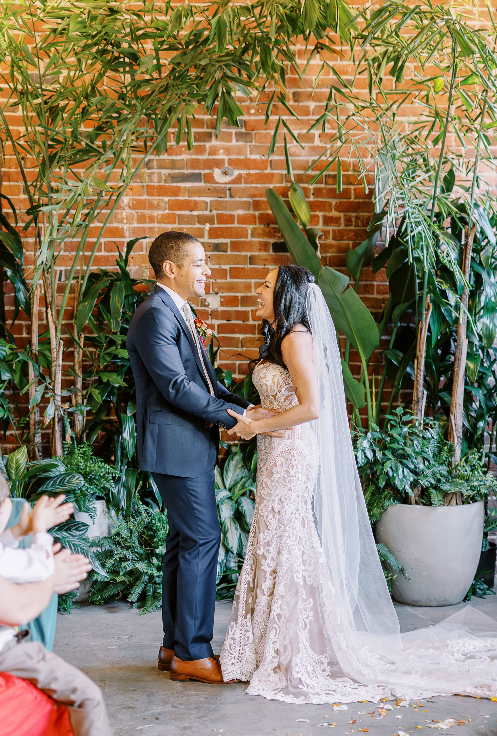 a bride and groom shares their first kiss as husband and wife at their midtown Sacramento wedding ceremony photographed by Sacramento wedding photographer