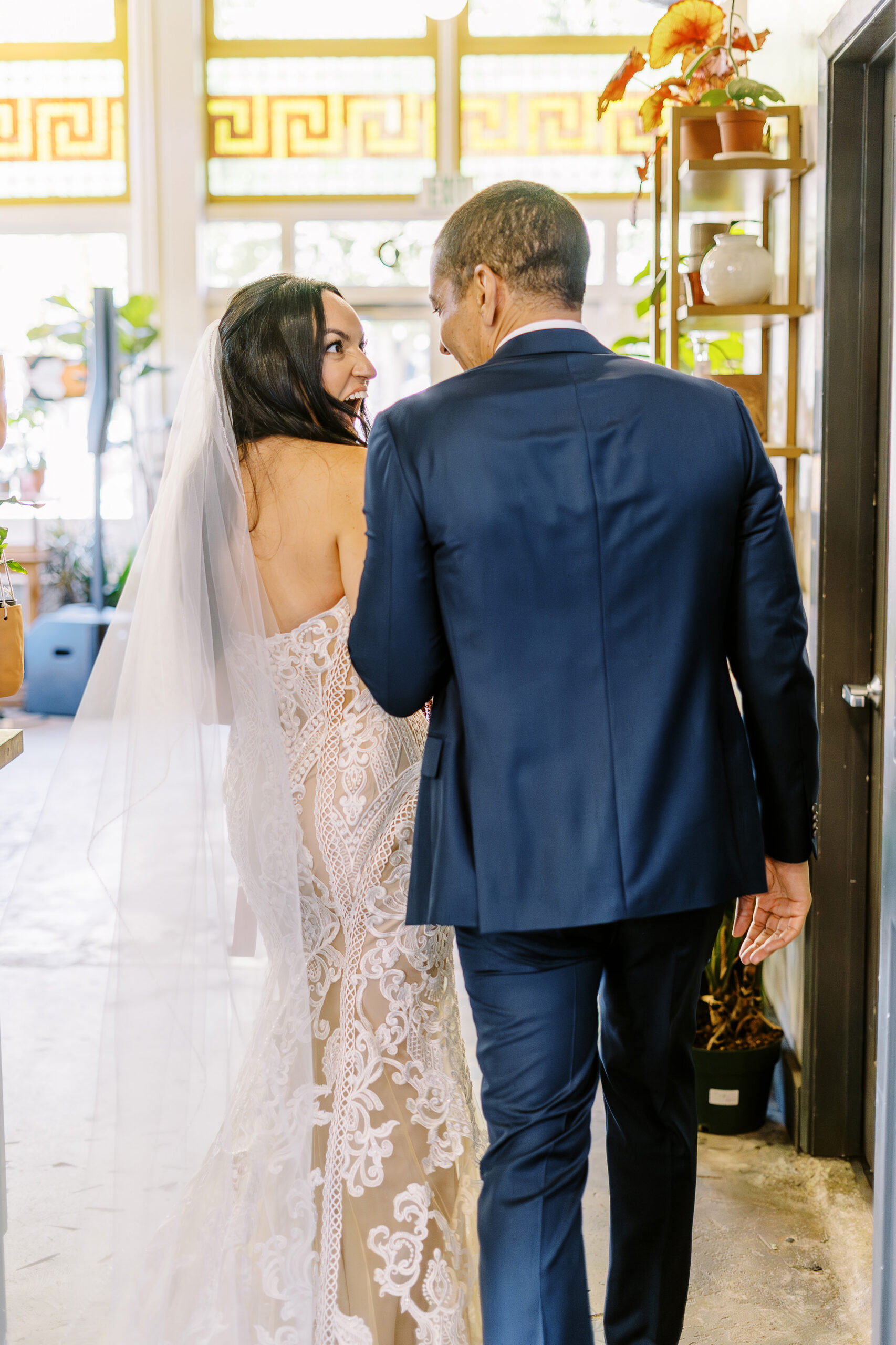 a bride and groom celebrate and laugh while walking down their aisle as husband and wife at their midtown Sacramento wedding ceremony photographed by Sacramento wedding photographer