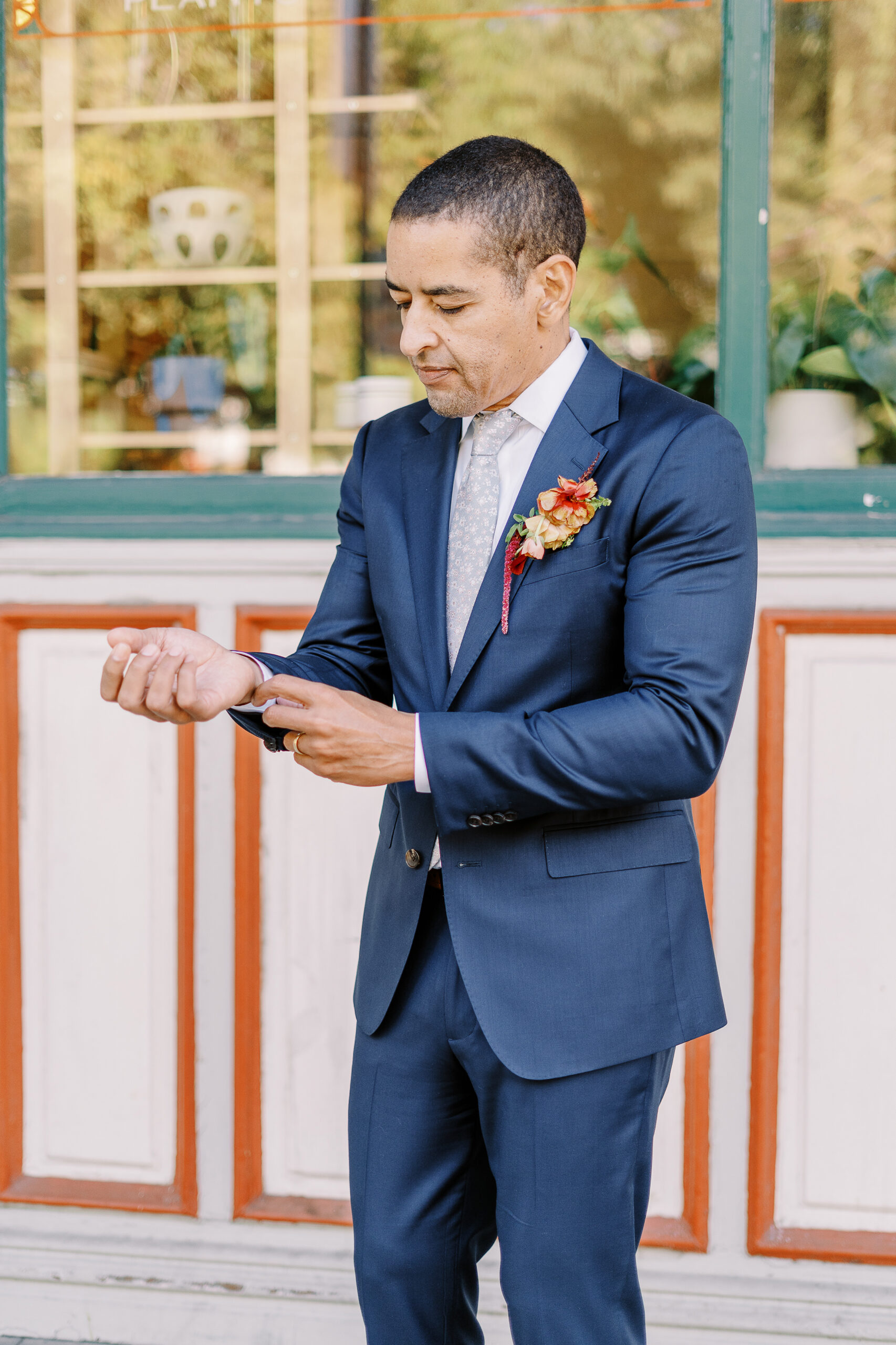 a groom adjusts his cuff links at his midtown Sacramento wedding photographed by Sacramento wedding photographer