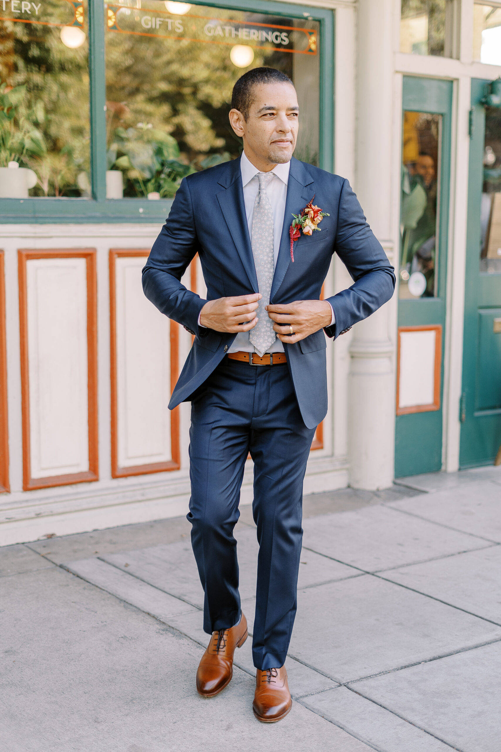a groom adjusts his jacket at his midtown Sacramento wedding photographed by Sacramento wedding photographer