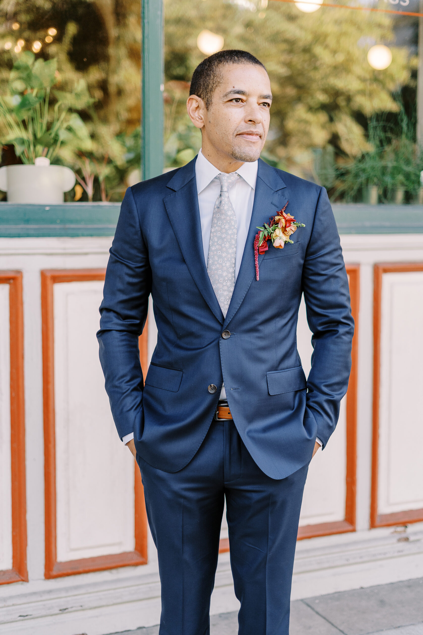 a groom poses for a portrait at his midtown Sacramento wedding photographed by Sacramento wedding photographer