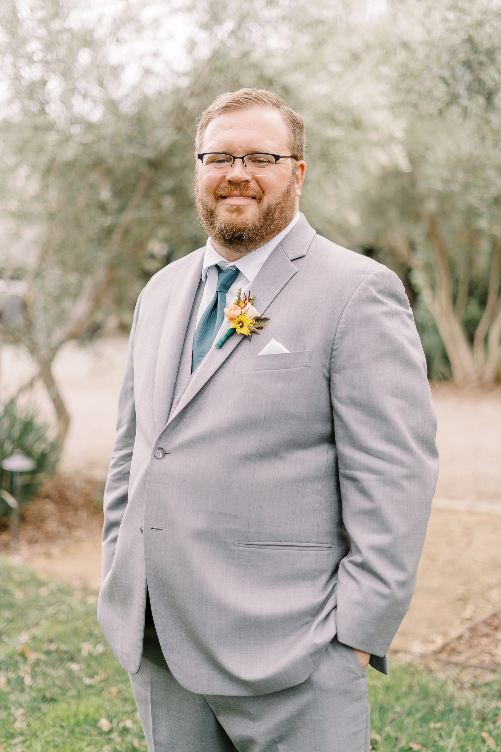 a groom poses for portraits at The Maples Woodland photographed by Sacramento wedding photographer