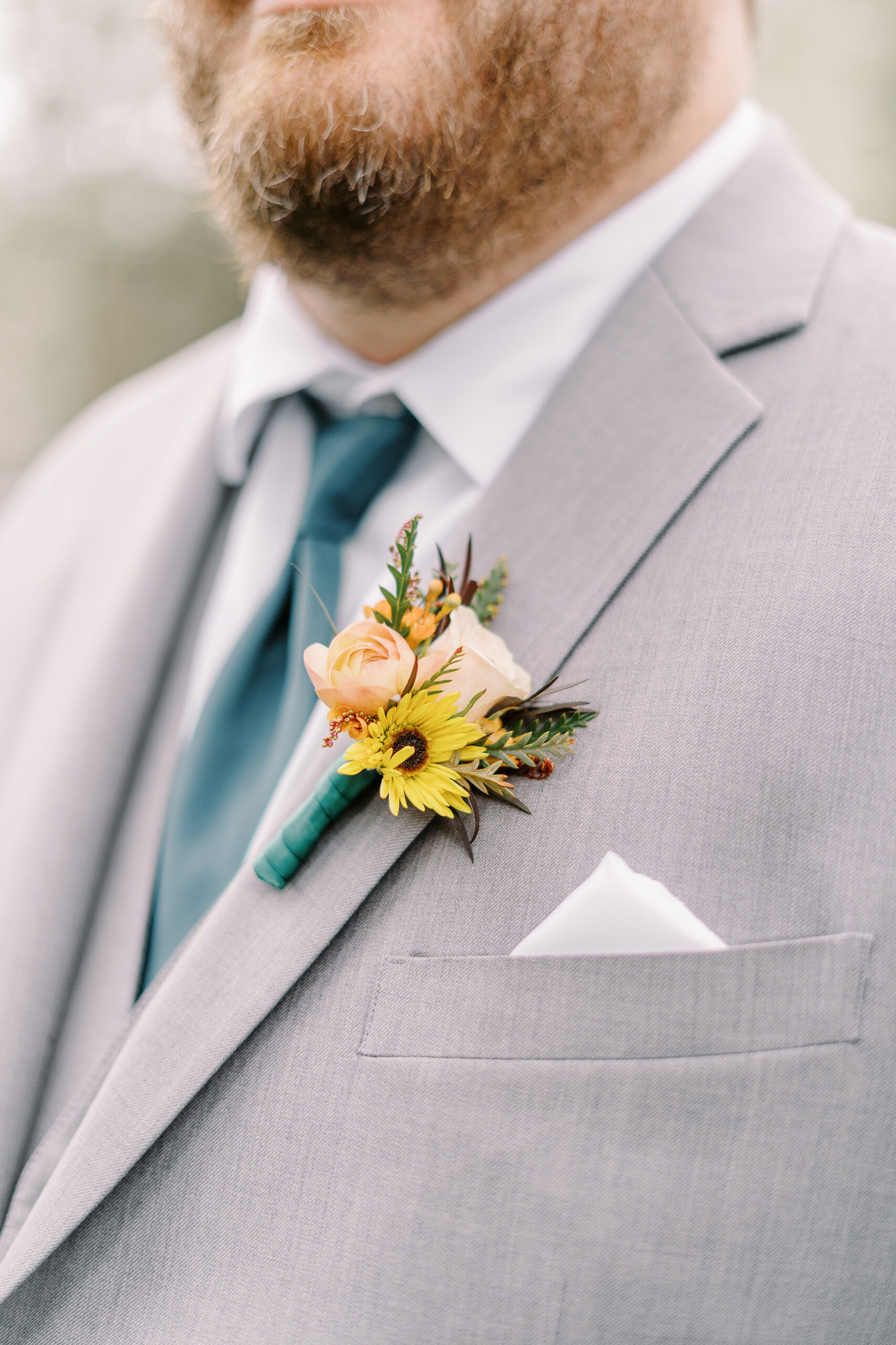 a groom boutonniere featuring sunflowers at The Maples Woodland photographed by Sacramento wedding photographer