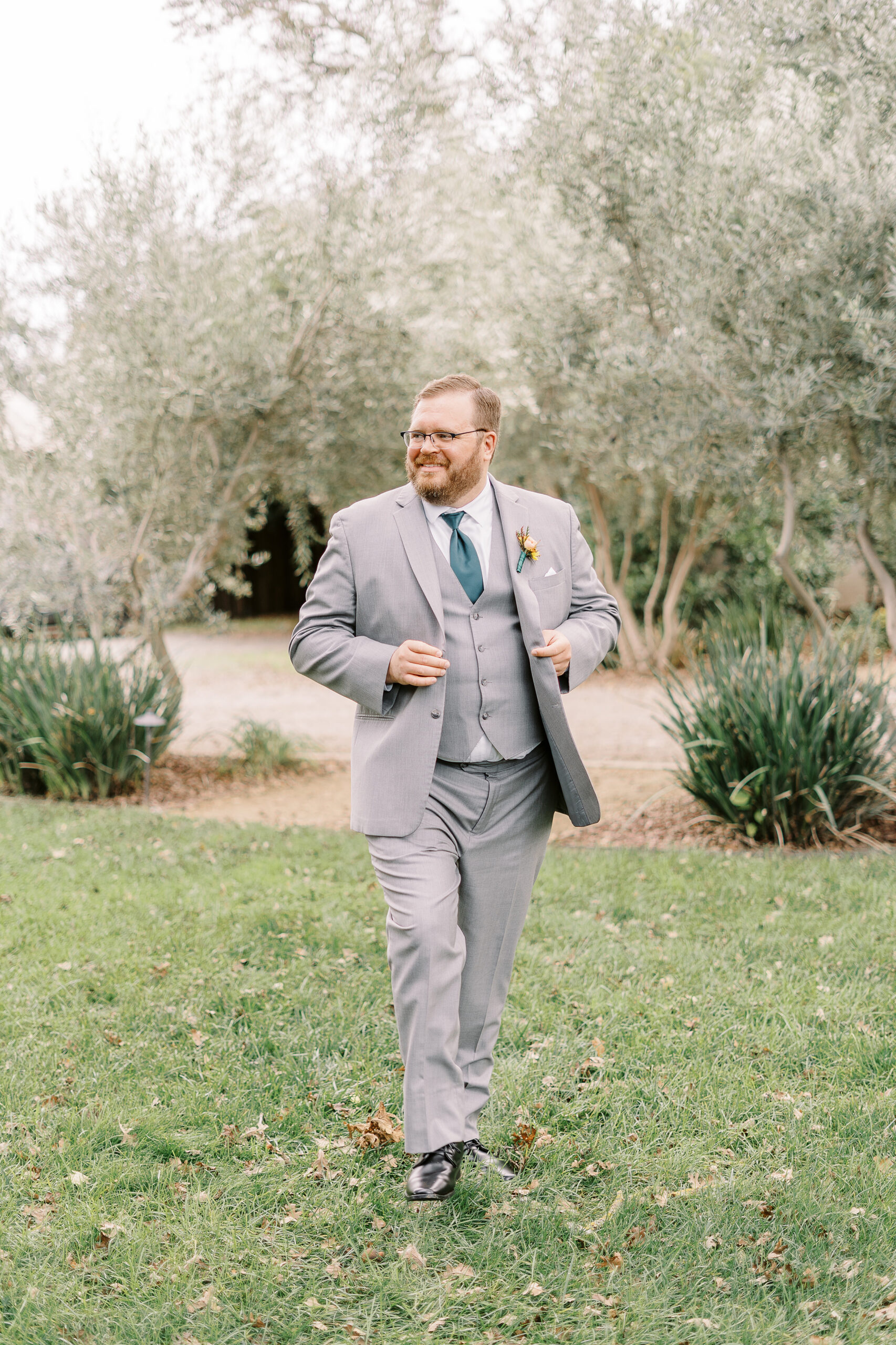 a groom poses for portraits at The Maples Woodland photographed by Sacramento wedding photographer