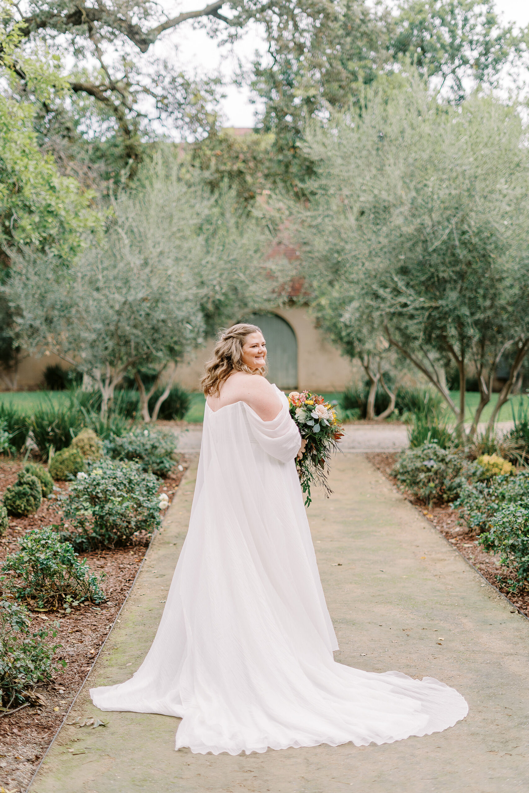 a bride poses for portraits at The Maples Woodland photographed by Sacramento wedding photographer
