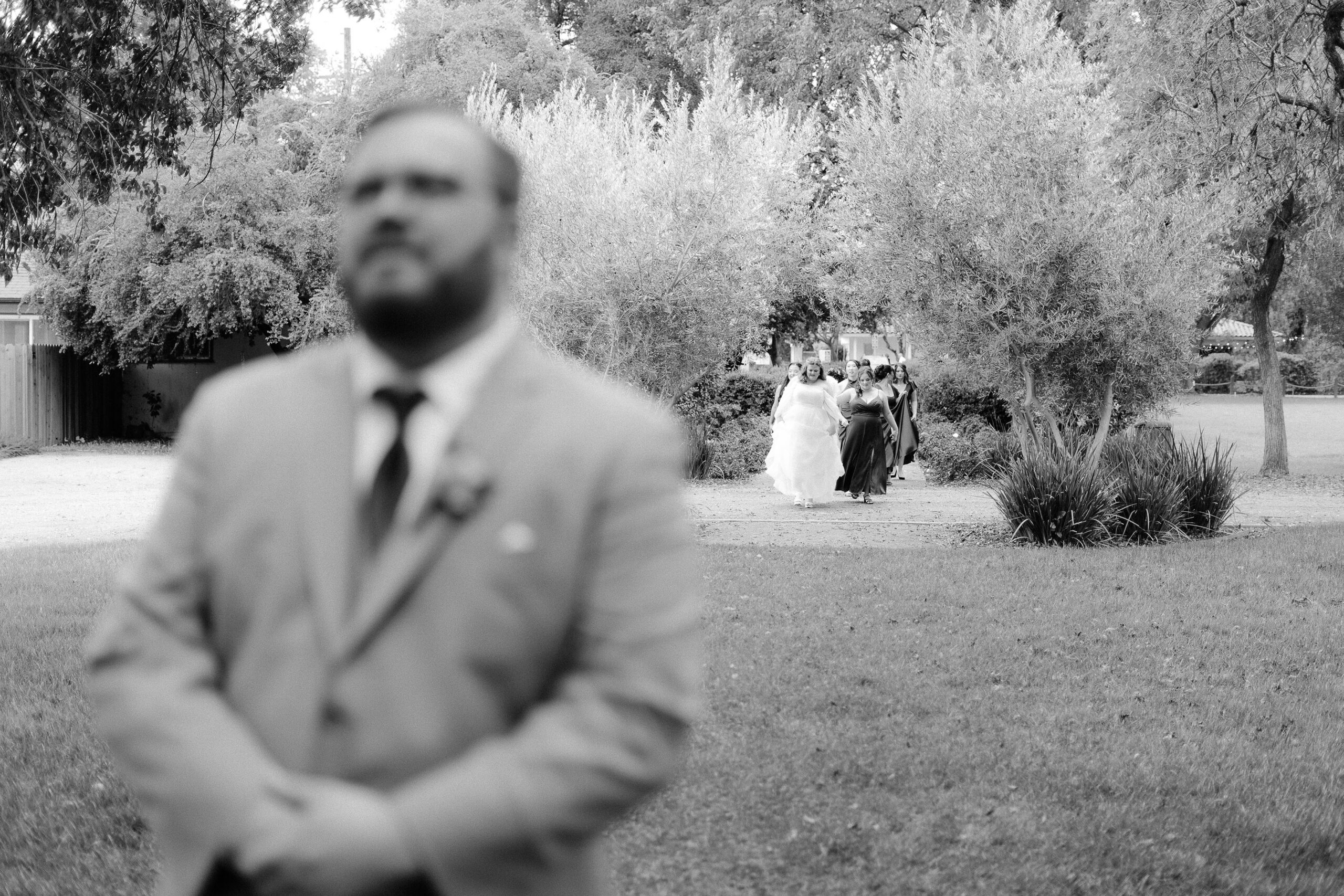 a groom anxiously awaits his bride for their first look at The Maples Woodland photographed by Sacramento wedding photographer