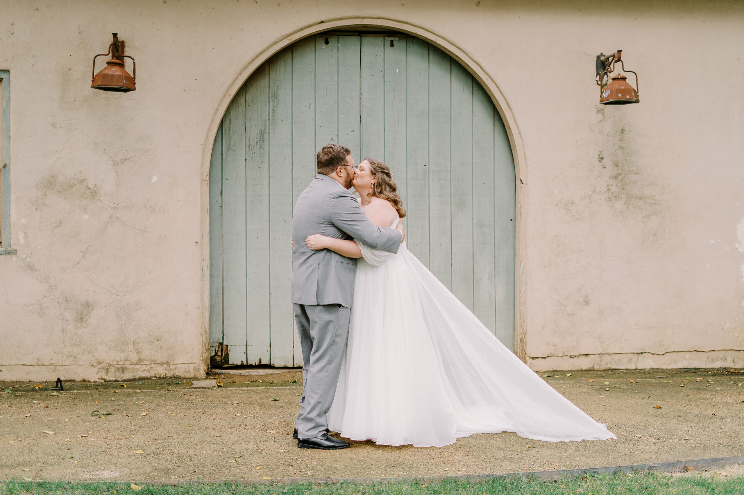 a bride and groom share their first look in front of the stables at The Maples Woodland photographed by Sacramento wedding photographer