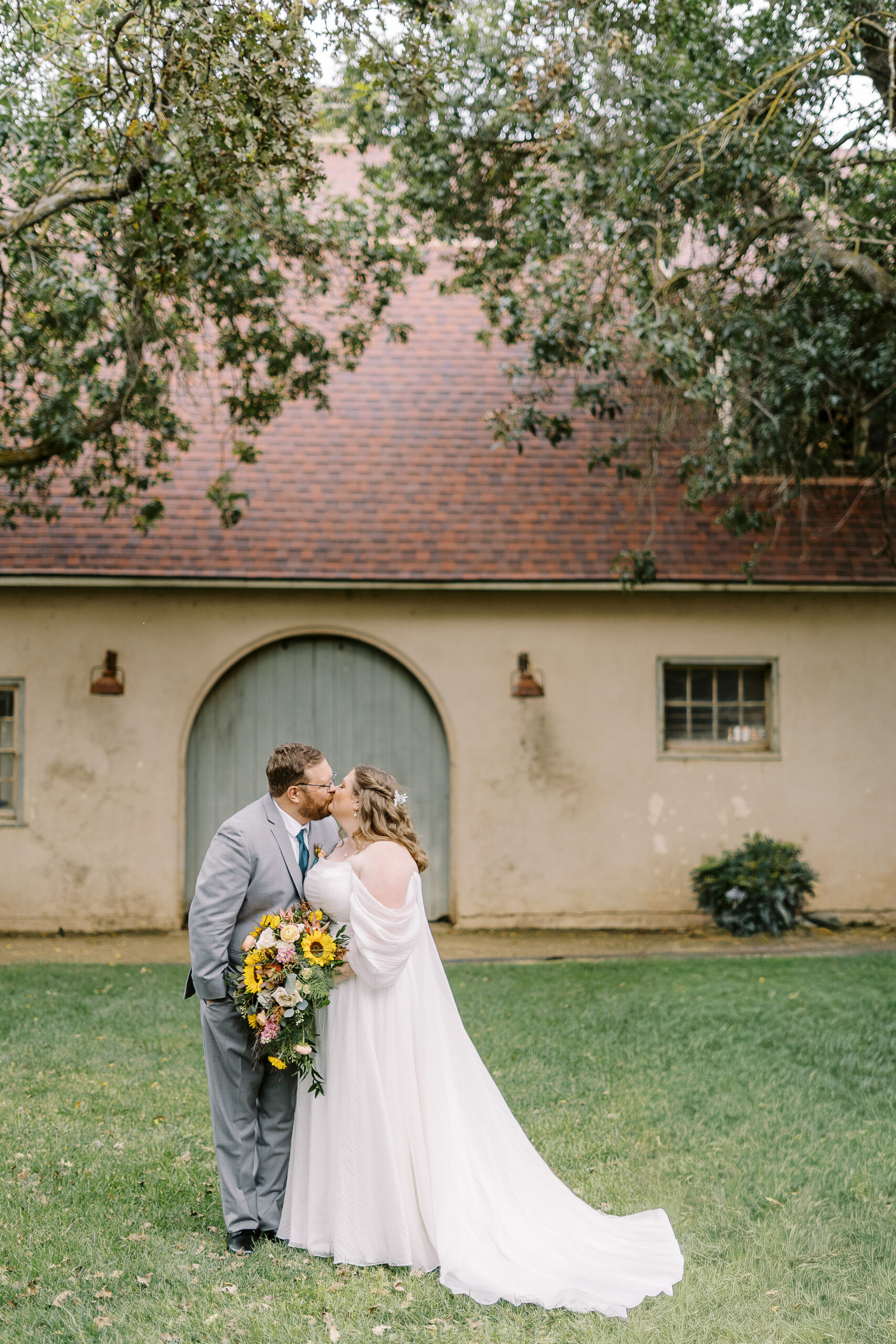 bride and groom portraits in front of the stables at The Maples Woodland photographed by Sacramento wedding photographer