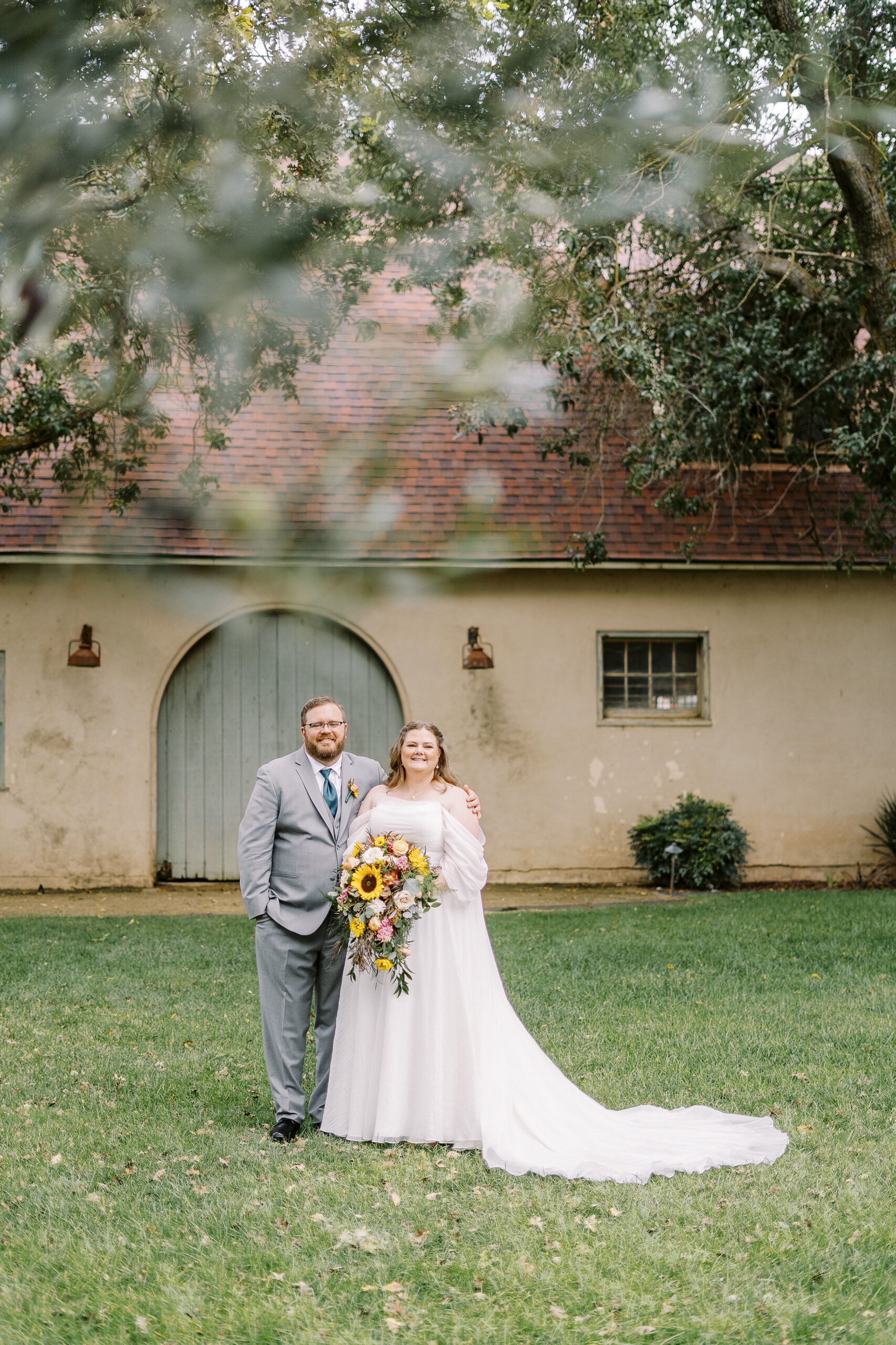 bride and groom portraits in front of the stables at The Maples Woodland photographed by Sacramento wedding photographer