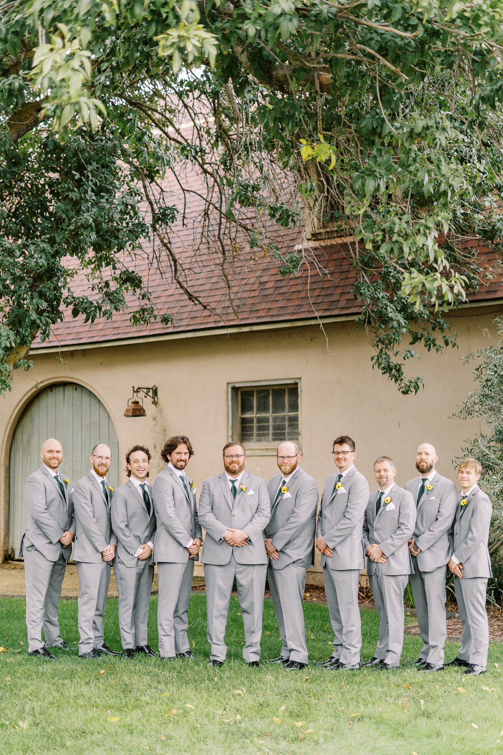 wedding party portraits in front of the stables at The Maples Woodland photographed by Sacramento wedding photographer