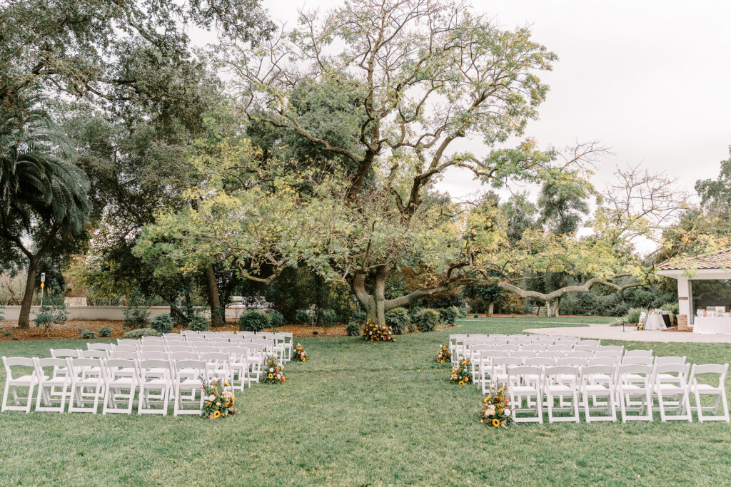 a wedding ceremony set up on the homestead main lawn at The Maples Woodland photographed by Sacramento wedding photographer