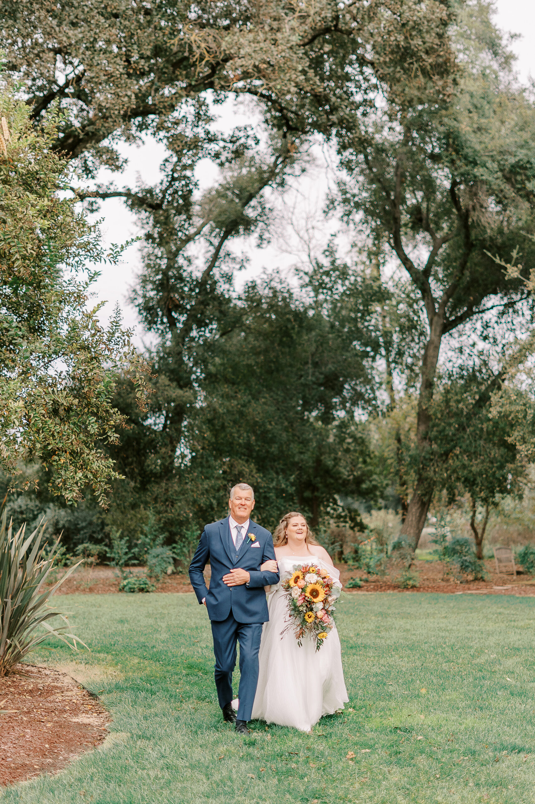 a brides father walks her down the aisle at The Maples Woodland photographed by Sacramento wedding photographer
