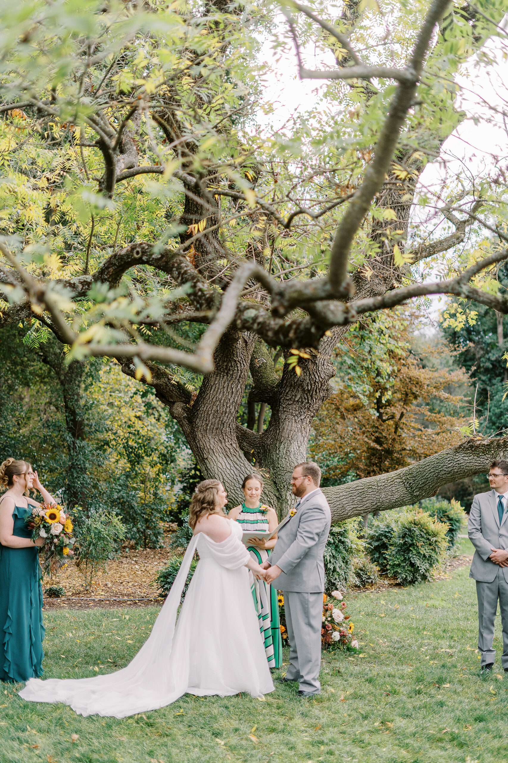 a bride and groom exchange vows during their wedding ceremony at The Maples Woodland photographed by Sacramento wedding photographer