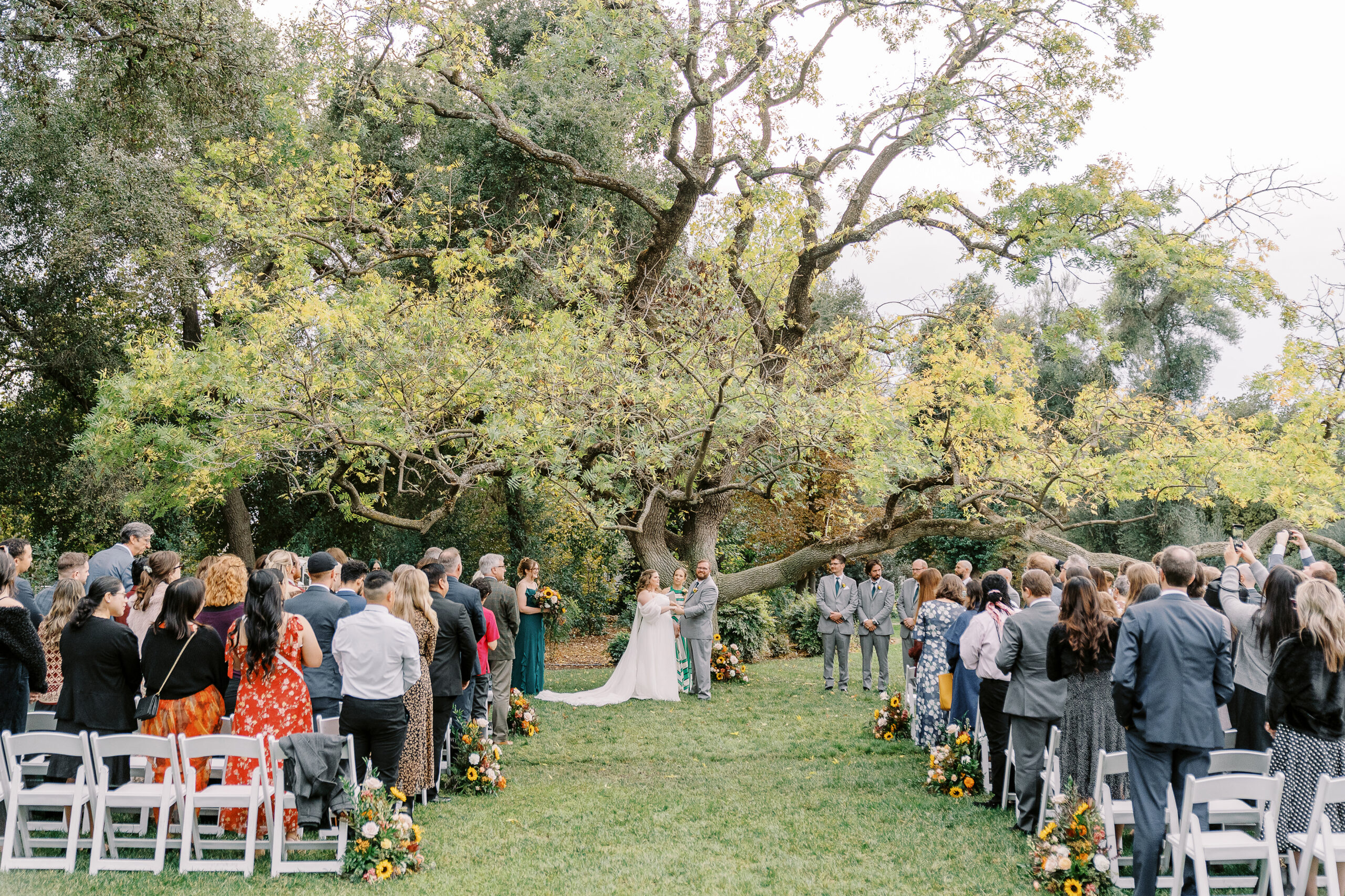a bride and groom exchange vows during their wedding ceremony at The Maples Woodland photographed by Sacramento wedding photographer