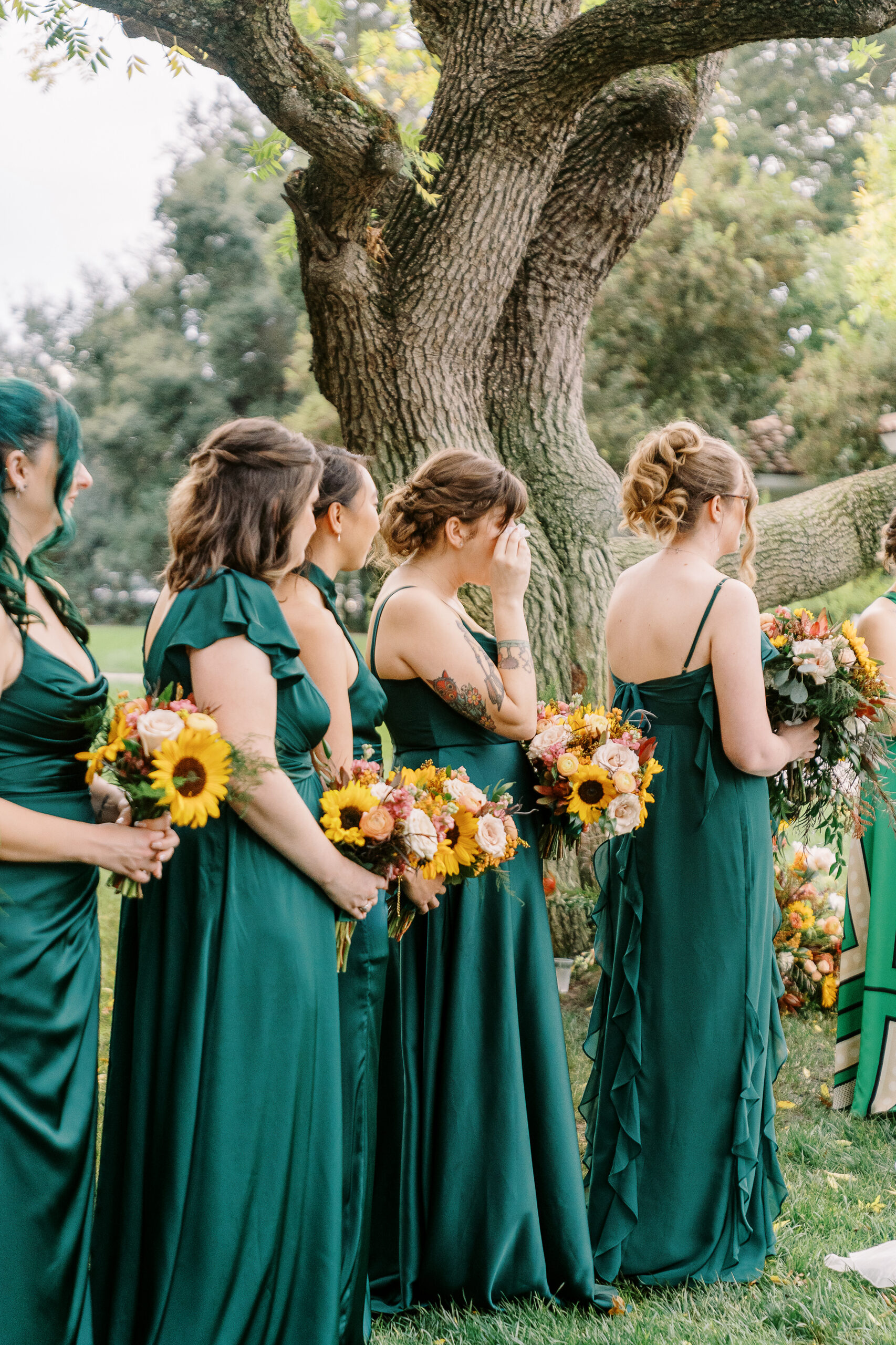 the maid of honor wipes away a tear at a ceremony at The Maples Woodland photographed by Sacramento wedding photographer