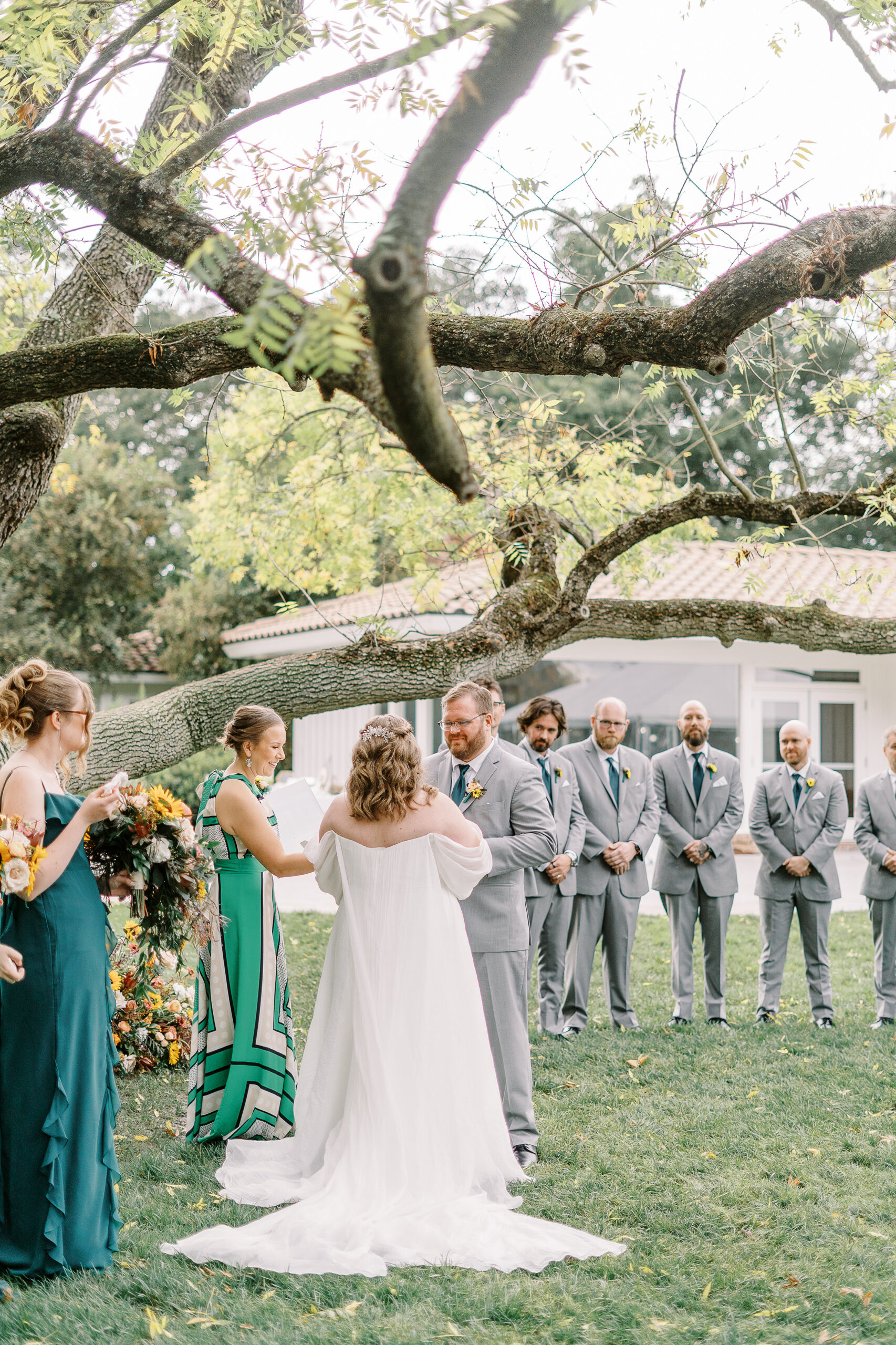 a bride and groom exchange vows during their wedding ceremony at The Maples Woodland photographed by Sacramento wedding photographer