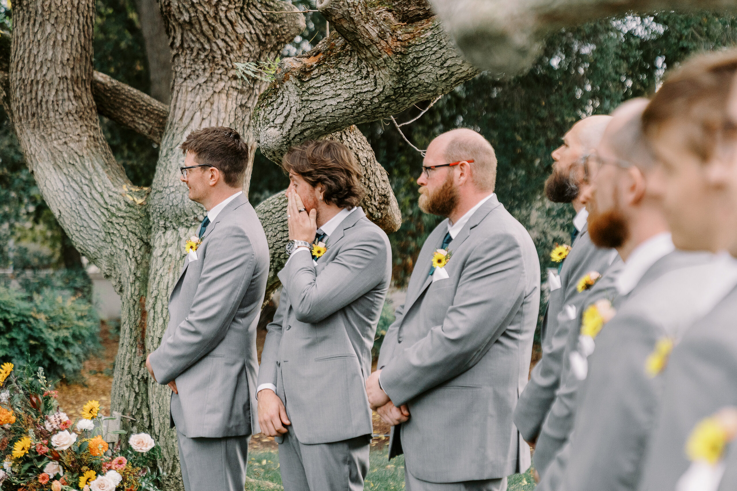 the grooms brother wipes away a tear at a ceremony at The Maples Woodland photographed by Sacramento wedding photographer