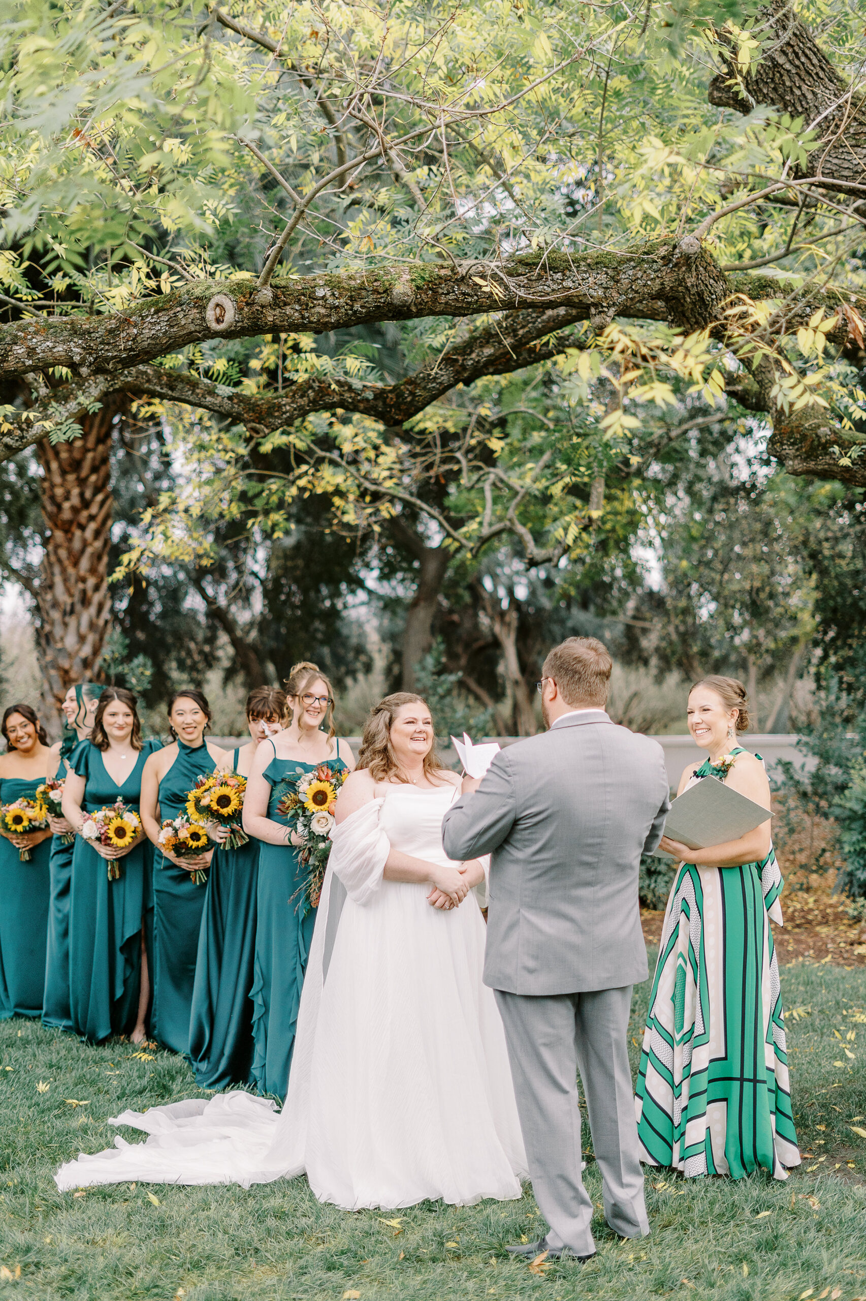 a bride and groom exchange vows during their wedding ceremony at The Maples Woodland photographed by Sacramento wedding photographer