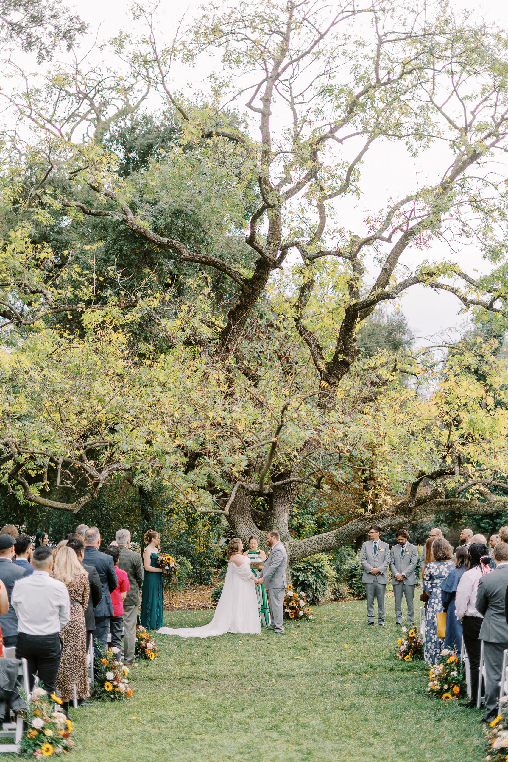 a bride and groom exchange vows during their wedding ceremony at The Maples Woodland photographed by Sacramento wedding photographer