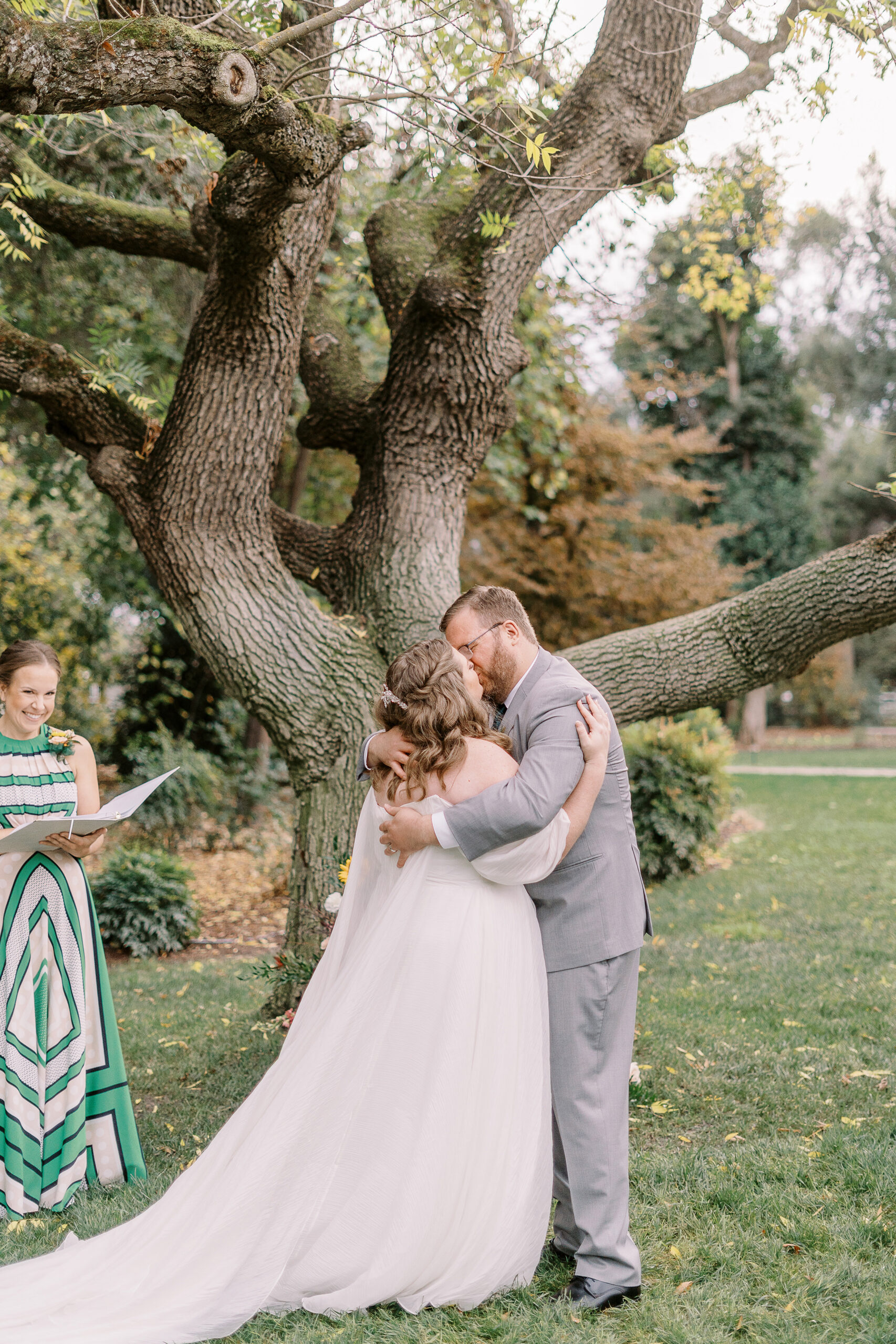 a bride and groom share their first kiss at a ceremony at The Maples Woodland photographed by Sacramento wedding photographer