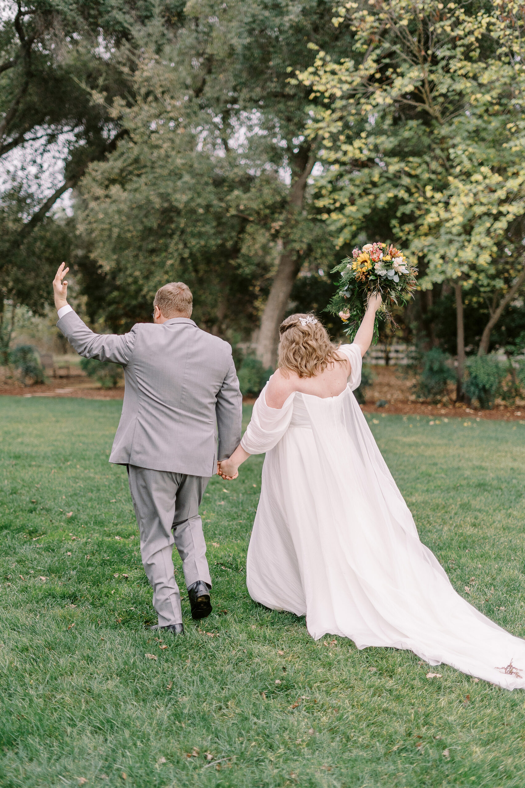 a bride and groom celebrate after their ceremony at The Maples Woodland photographed by Sacramento wedding photographer