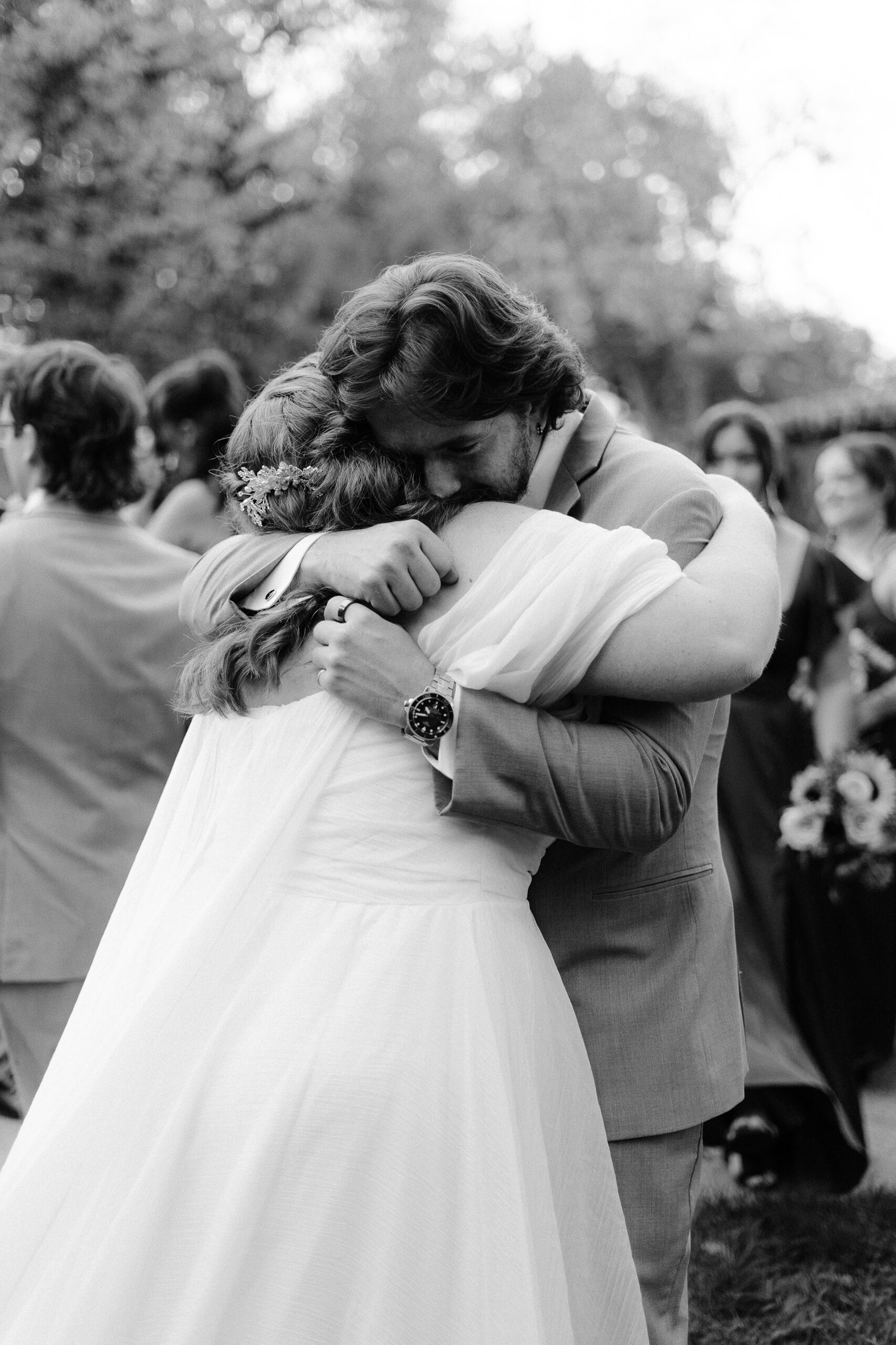 the brother of the groom cries and hugs the bride at The Maples Woodland photographed by Sacramento wedding photographer