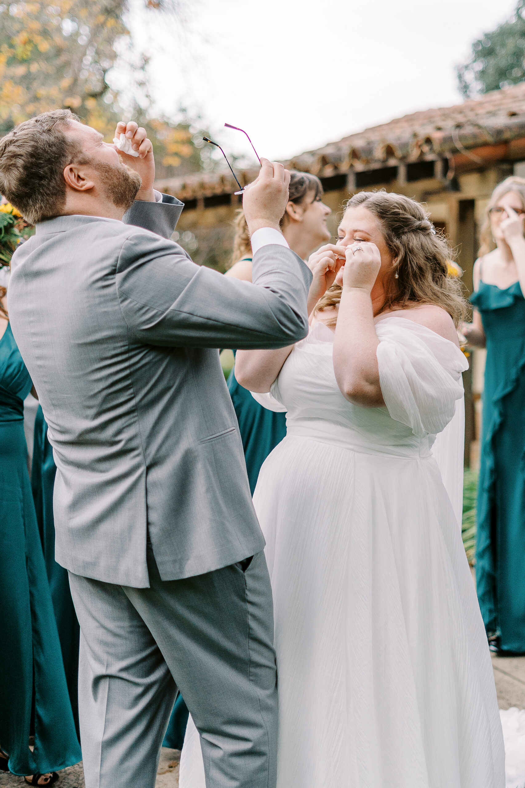 a bride and groom cry and laugh together after their wedding ceremony at The Maples Woodland photographed by Sacramento wedding photographer