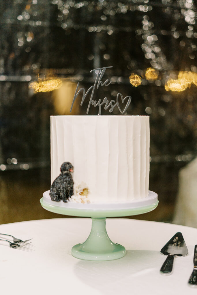a custom wedding cake featuring the bride and grooms dog as a cake decoration at The Maples Woodland photographed by Sacramento wedding photographer