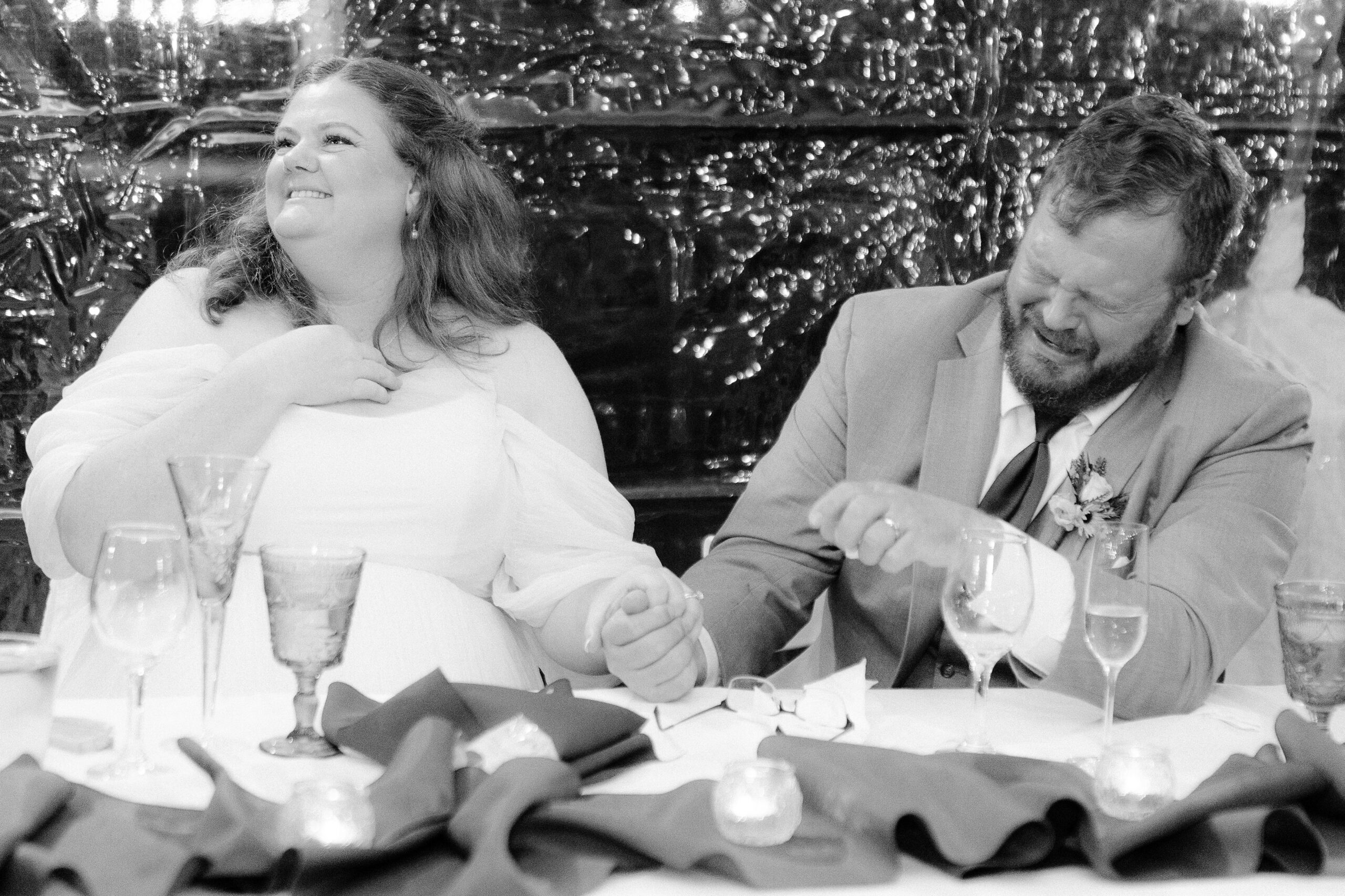 a bridge and groom laugh and cry while listening to toasts during their reception at The Maples Woodland photographed by Sacramento wedding photographer